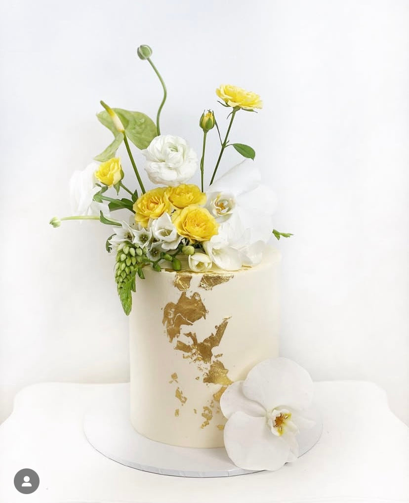 A stylish floral arrangement showcasing a mix of white flowers and yellow accents, representing Tiffany Flowers: Pastel Pure Perfumes Bouquet by Naked Fern Florals, ideal for luxurious birthday flower gifts.
#brisbaneflorist #everydayflowers #mothersdayflowers #Nakedfernflowers #weddingflowers